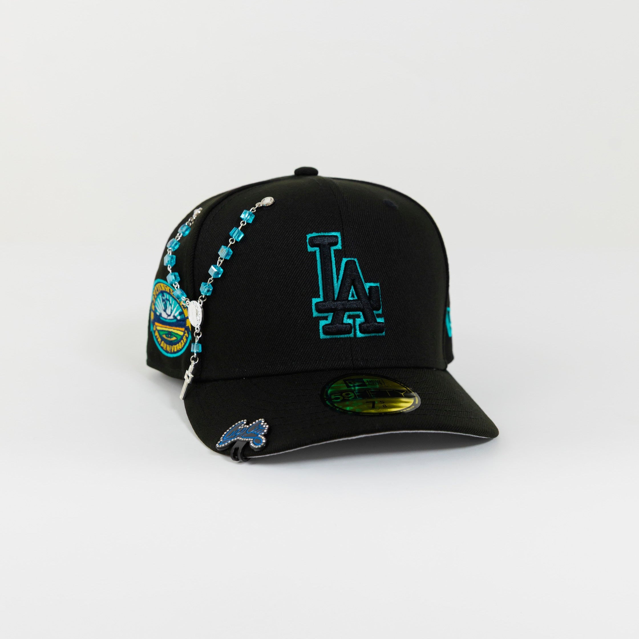 NEW ERA 59FIFTY BLACKED OUT LOS ANGELES DODGERS W/ TEAL OUTLINE + 50TH ANNIVERSARYSIDE PATCH