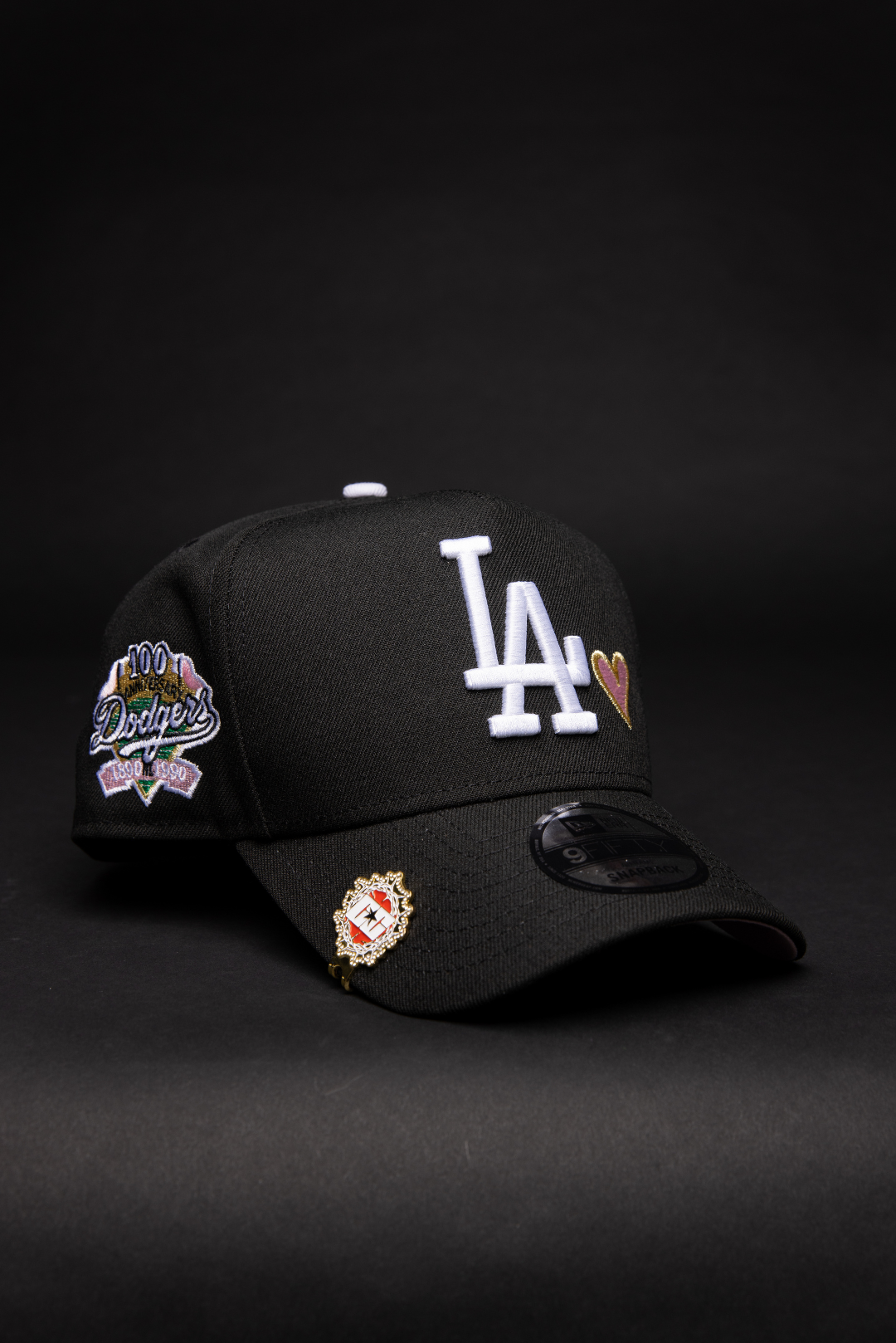 NEW ERA 9FIFTY A-FRAME BLACK LOS ANGELES DODGERS SNAPBACK W/ PINK HEART + 100TH ANNIVERSARYSIDE PATCH