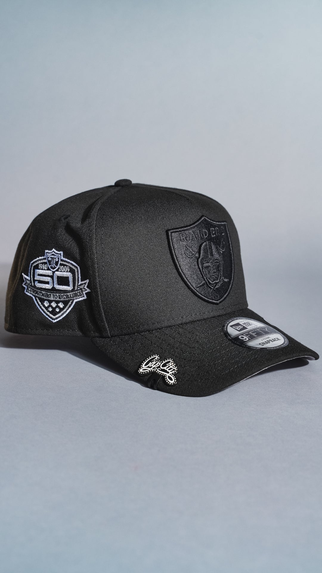 NEW ERA 9FIFTY A-FRAME BLACKED OUT LAS VEGAS RAIDERS SNAPBACK W/ 50TH ANNIVERSARY SIDE PATCH