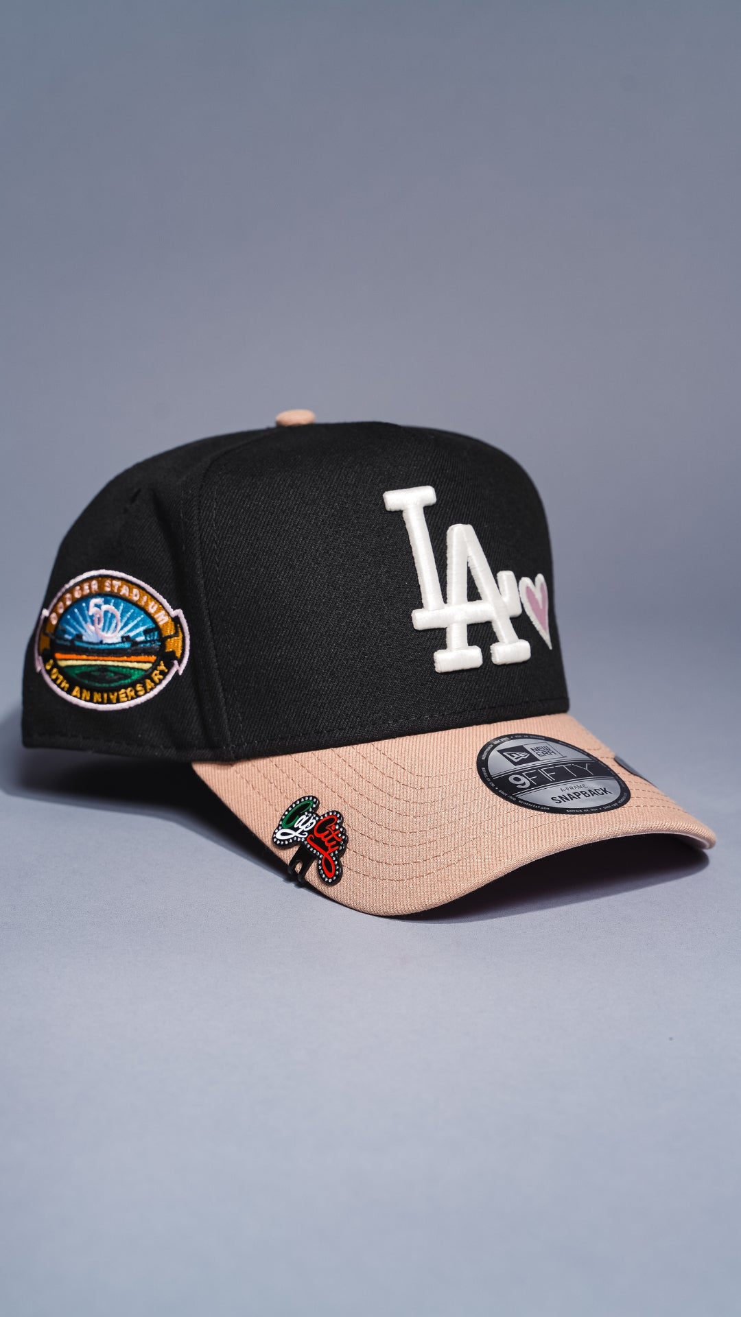 NEW ERA 9FIFTY A-FRAME BLACK/KHAKI LOS ANGELES DODGERS SNAPBACK W/ PINK HEART + 50TH ANNIVERSARY SIDE PATCH