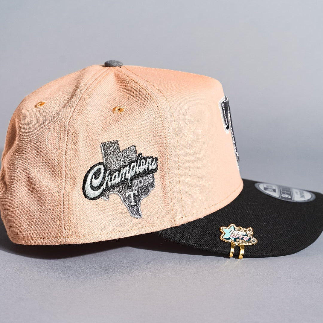 NEW ERA 9FIFTY A-FRAME BLUSH/BLACK TEXAS RANGERS SNAPBACK W/ WORLD SERIES CHAMPIONS SIDE PATCH