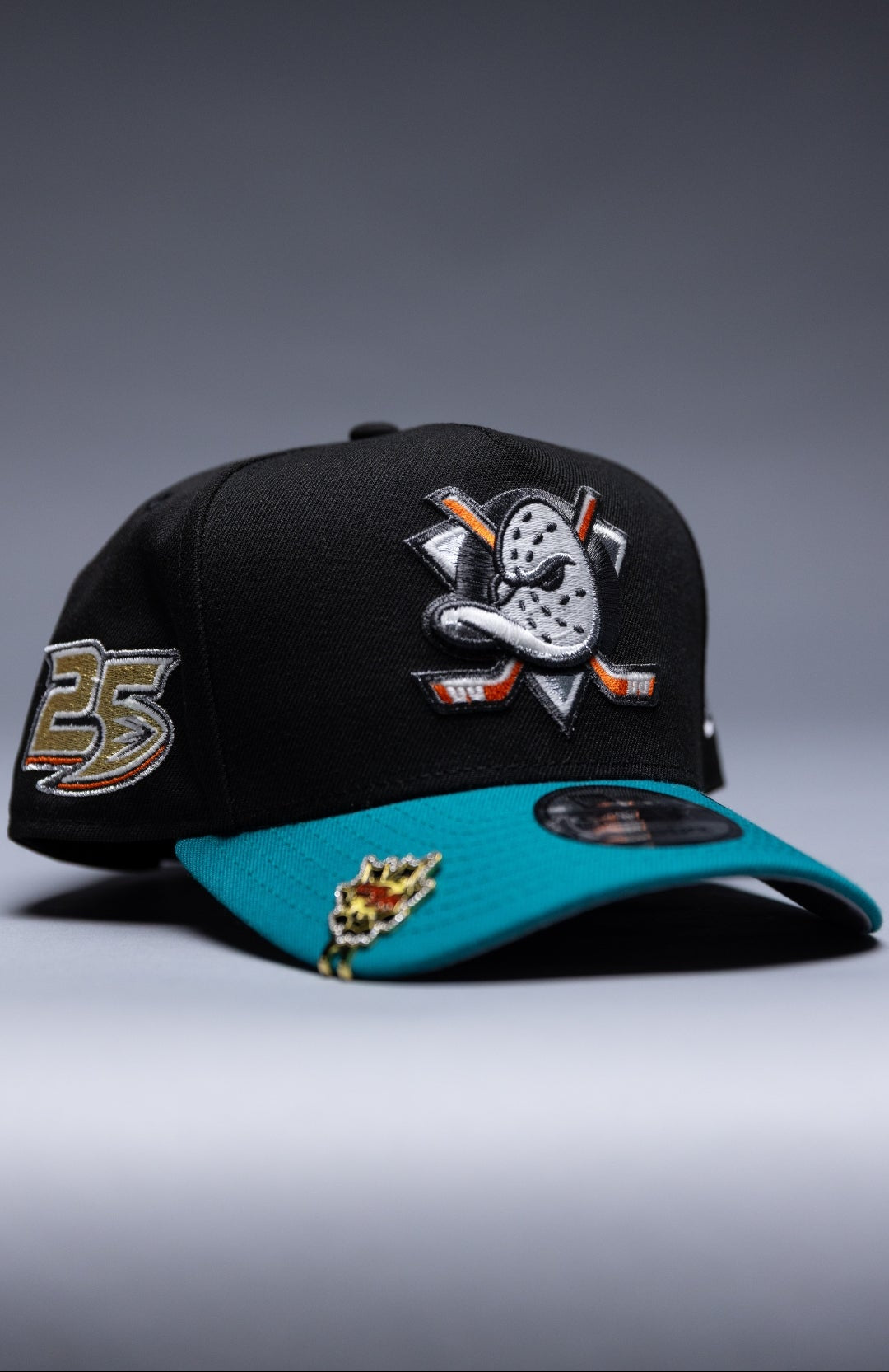 NEW ERA 9FIFTY A-FRAME BLACK/TEAL ANAHEIM DUCKS SNAPBACK W/ 25TH ANNIVERSARY SIDE PATCH
