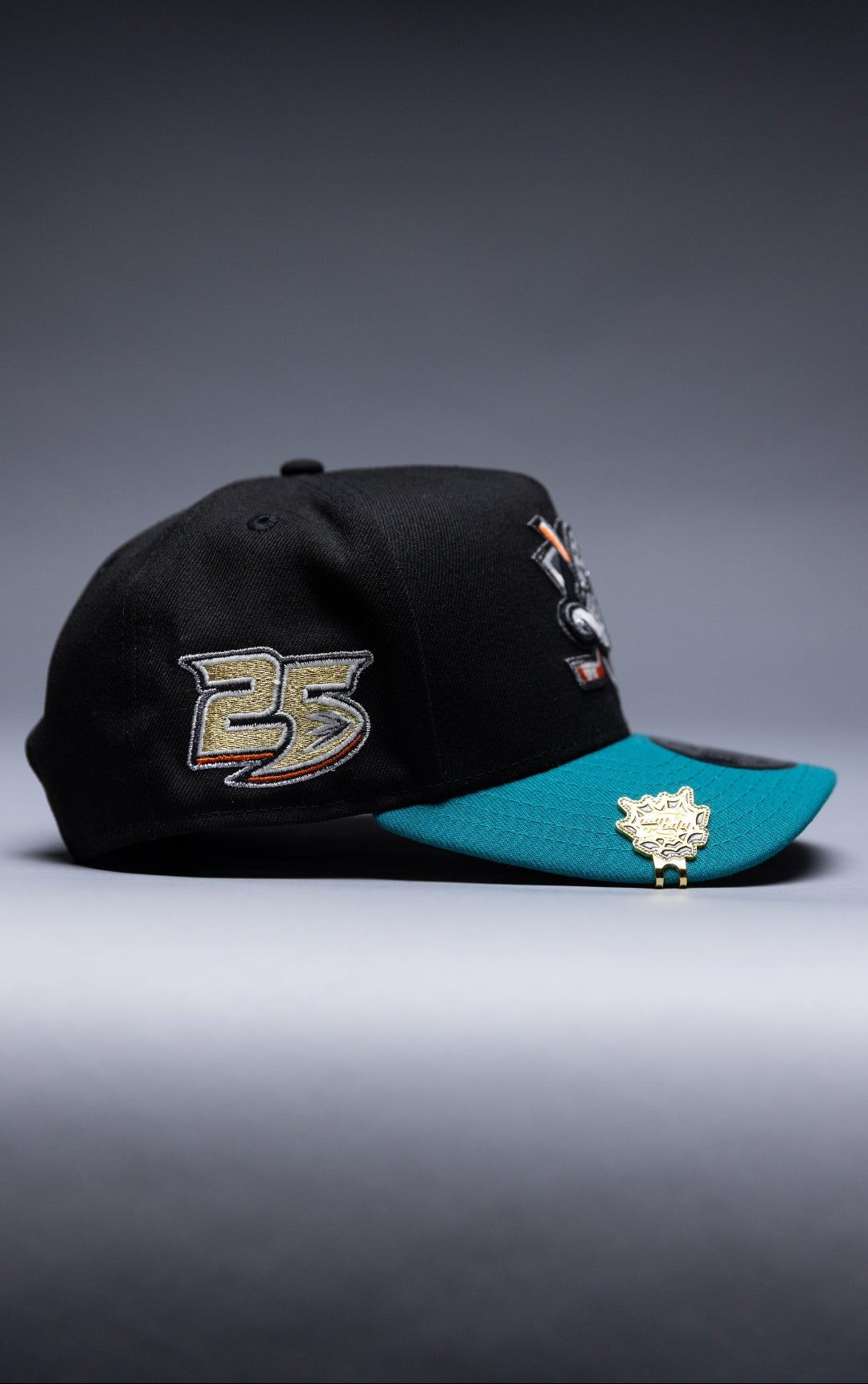 NEW ERA 9FIFTY A-FRAME BLACK/TEAL ANAHEIM DUCKS SNAPBACK W/ 25TH ANNIVERSARY SIDE PATCH