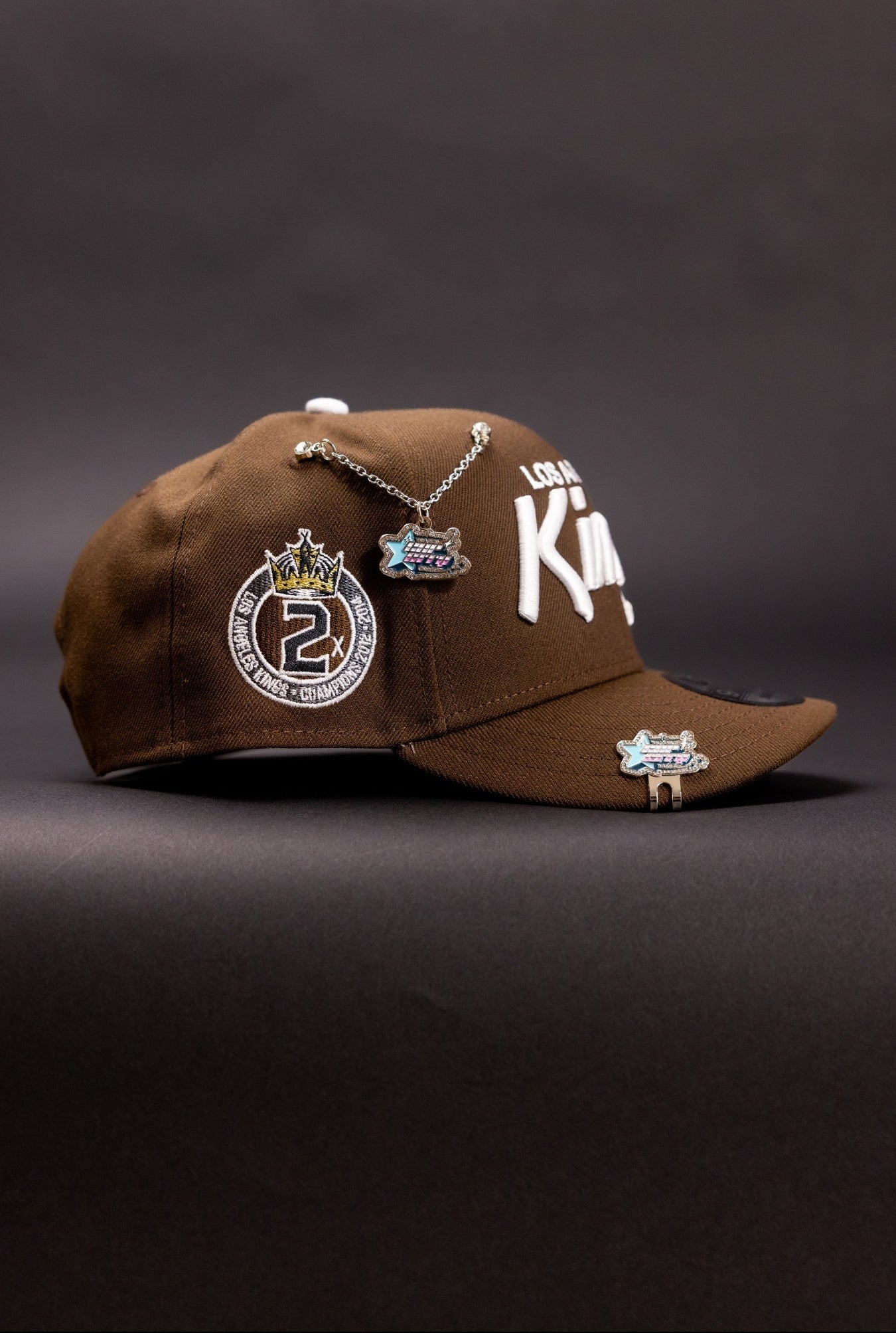 NEW ERA 9FIFTY BROWN LOS ANGELES KINGS SCRIPT SNAPBACK W/ "2X CHAMPS" SIDE PATCH